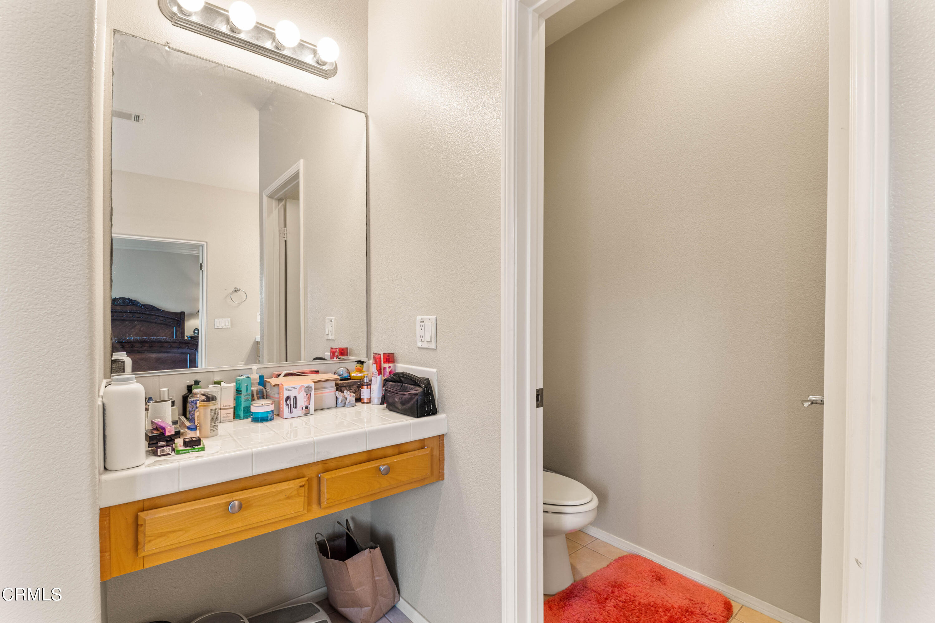 1620 Rubio Circle Oxnard, CA 93030 - Photo 27 of 68 a bathroom with a sink vanity mirror and toilet