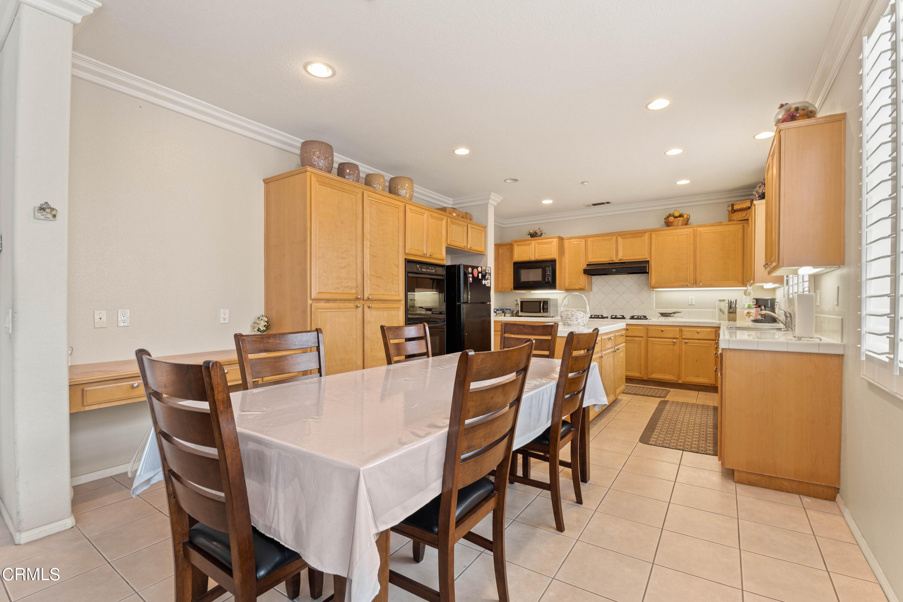 1620 Rubio Circle Oxnard, CA 93030 - Photo 45 of 68 a dining room with stainless steel appliances kitchen island granite countertop a dining table chairs and a refrigerator