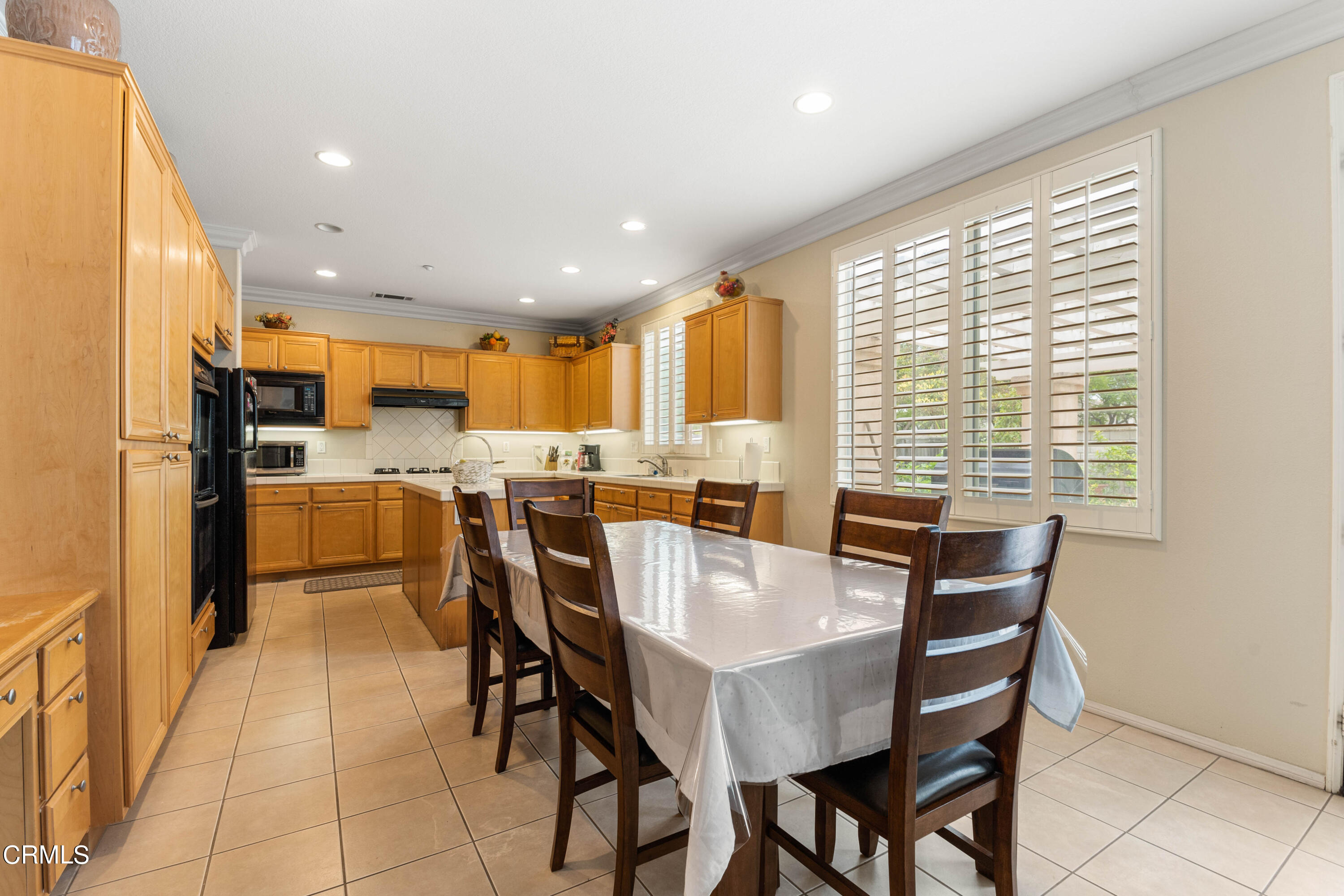 1620 Rubio Circle Oxnard, CA 93030 - Photo 46 of 68 a dining room with stainless steel appliances a table and chairs