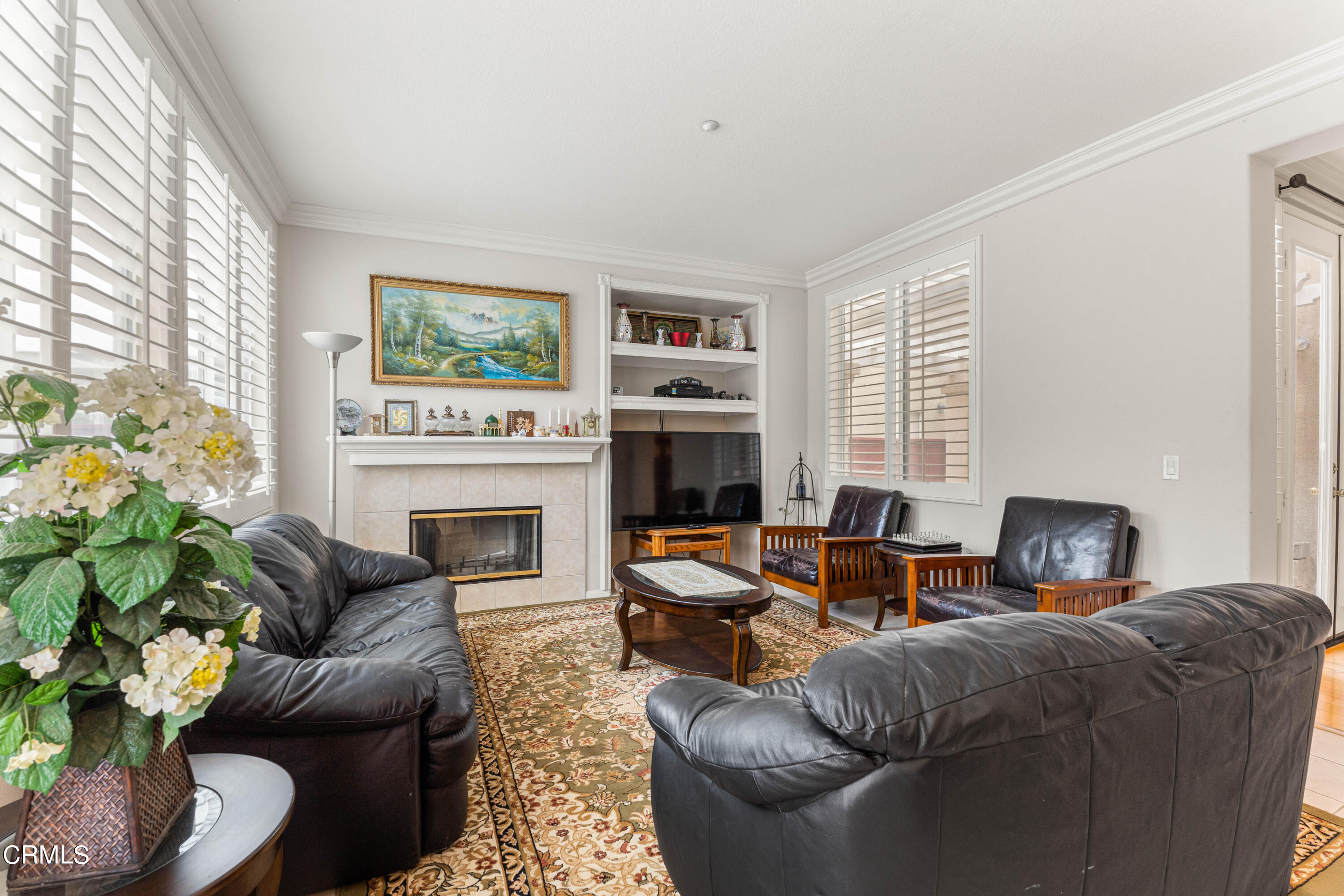 1620 Rubio Circle Oxnard, CA 93030 - Photo 48 of 68 a living room with furniture a large window and a fireplace