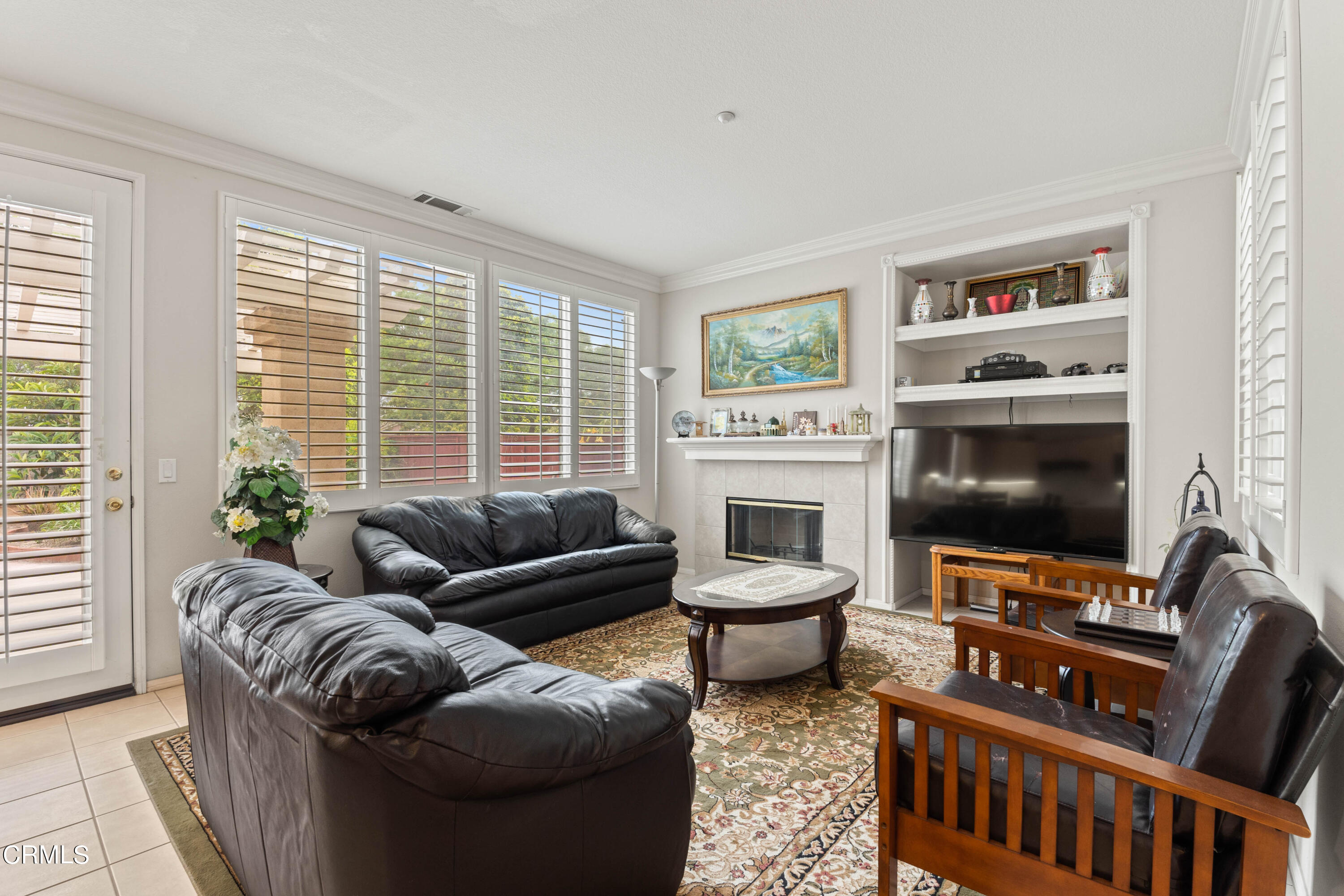 1620 Rubio Circle Oxnard, CA 93030 - Photo 49 of 68 a living room with furniture a flat screen tv and a floor to ceiling window