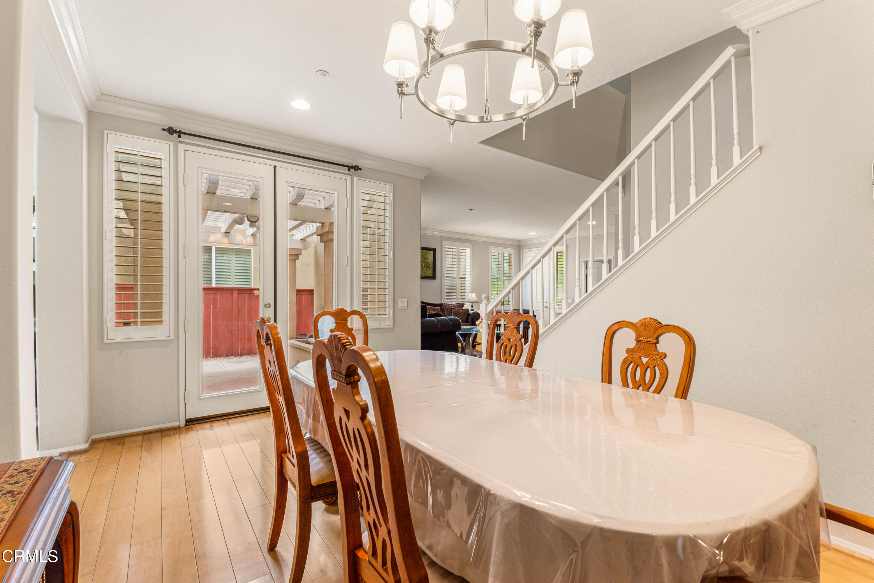 1620 Rubio Circle Oxnard, CA 93030 - Photo 51 of 68 a dining room with furniture a chandelier and wooden floor