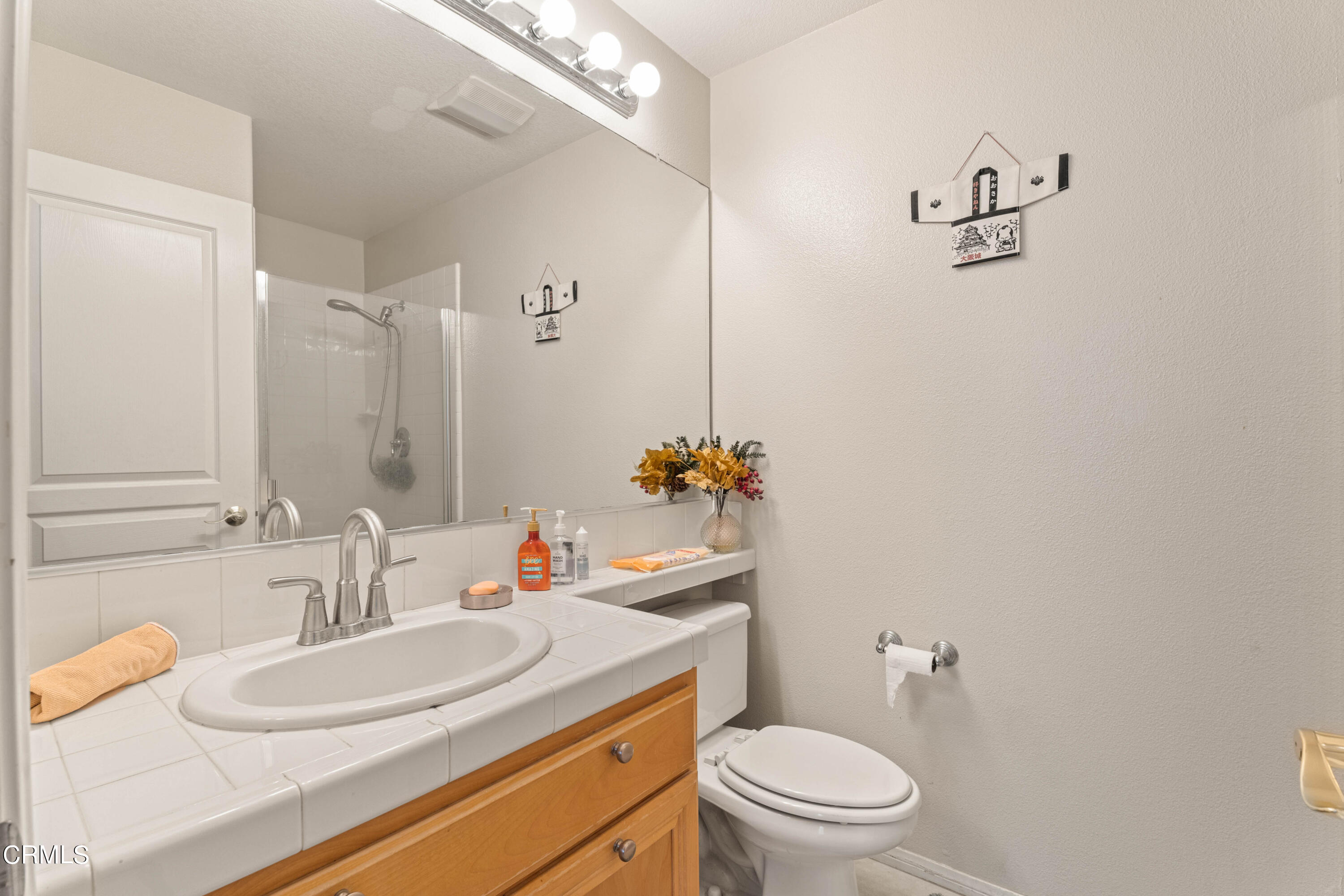 1620 Rubio Circle Oxnard, CA 93030 - Photo 54 of 68 a bathroom with a granite countertop sink a toilet and a mirror