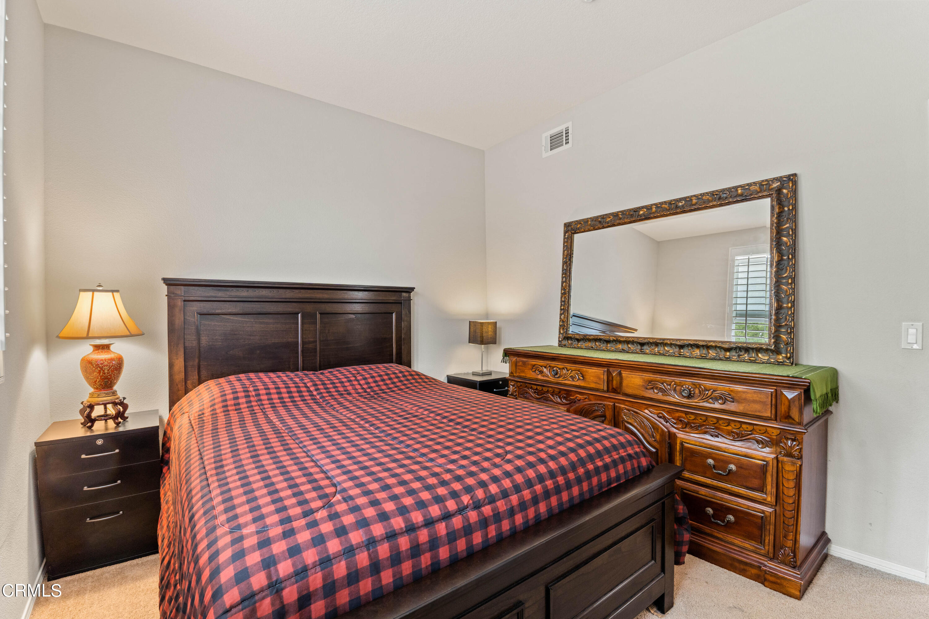 1620 Rubio Circle Oxnard, CA 93030 - Photo 56 of 68 a bedroom with a bed and a mirror on dresser