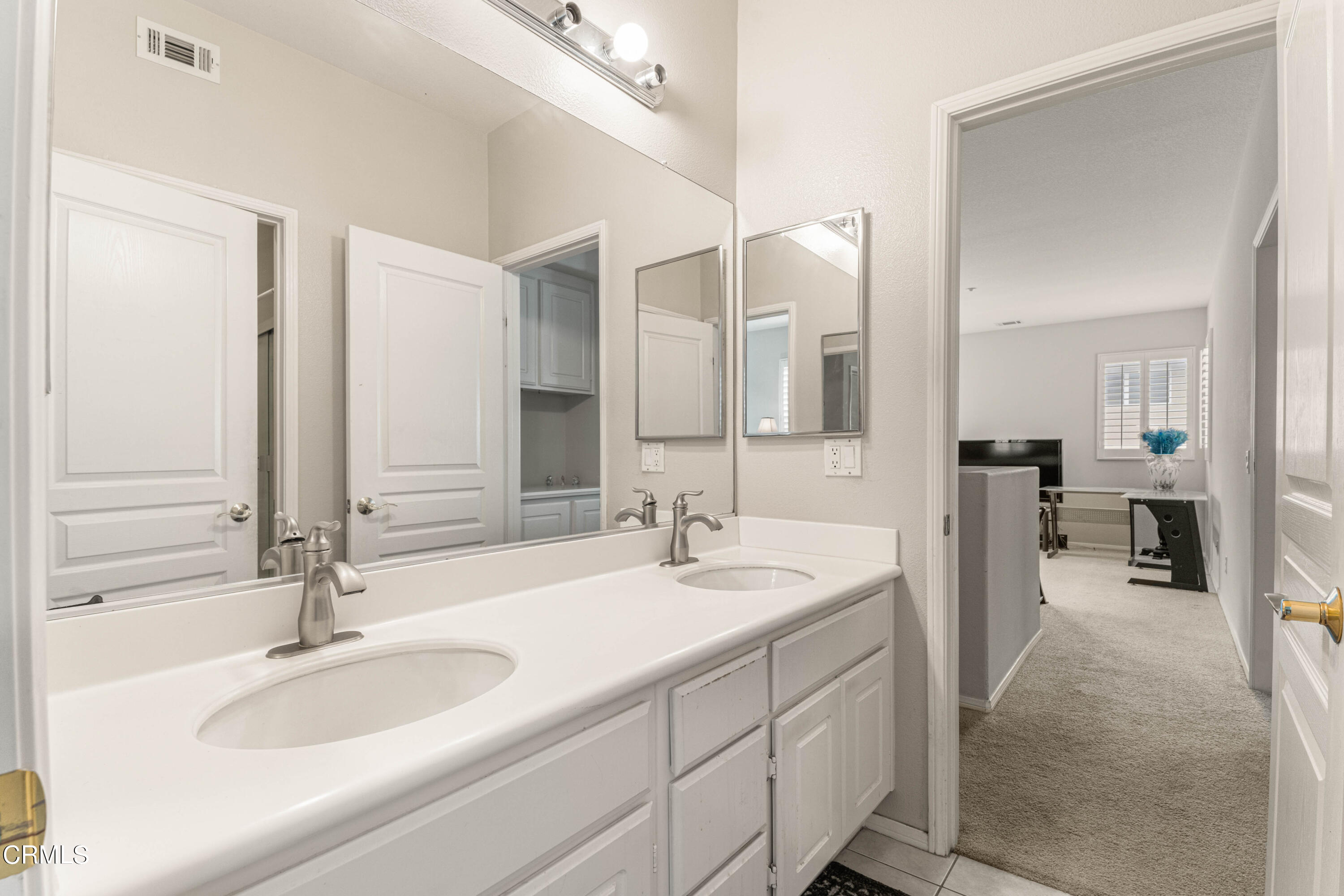 1620 Rubio Circle Oxnard, CA 93030 - Photo 63 of 68 a spacious bathroom with a double vanity sink and a mirror