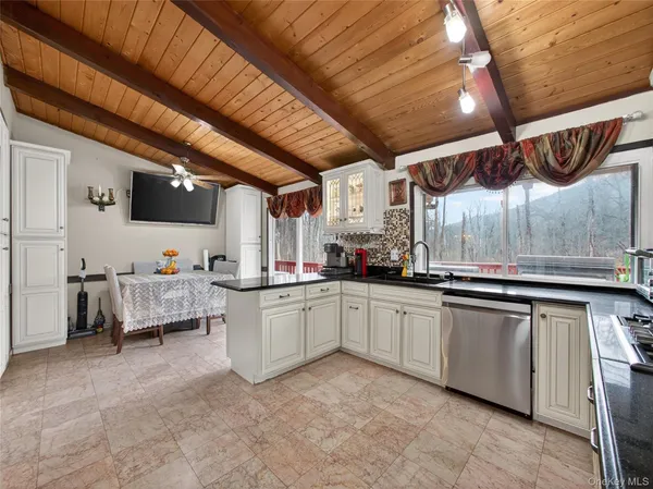 a large white kitchen with a large window