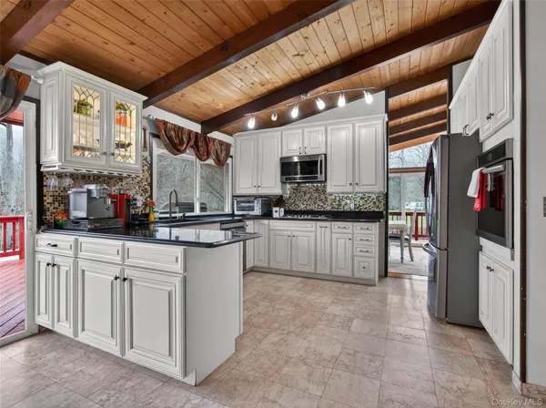 a kitchen with stainless steel appliances granite countertop a stove sink and cabinets