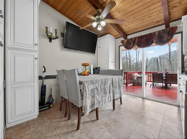 a view of a livingroom with furniture and a flat screen tv