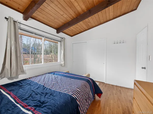 a bed sitting in a bedroom next to a window