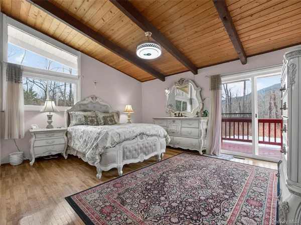 a bedroom with a bed and a wooden floor