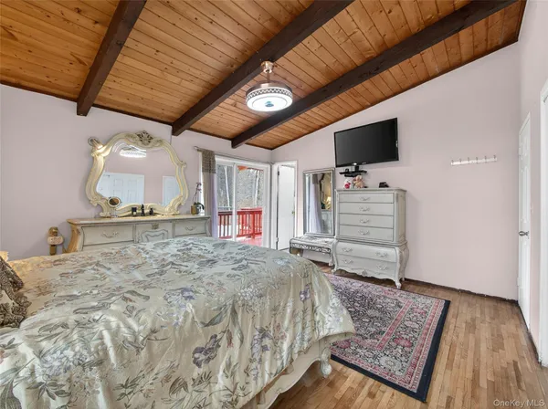 a bed room with a bed and a television
