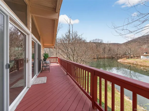 a view of a balcony with wooden floor and fence