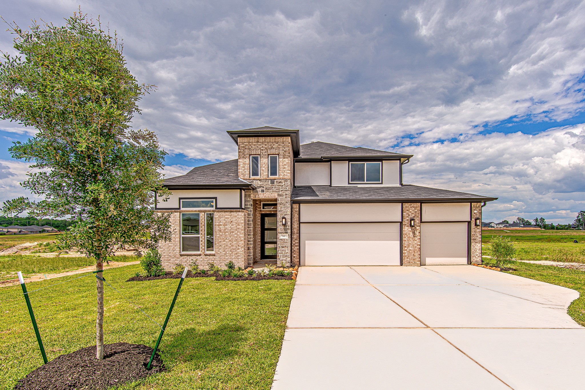 A striking modern exterior with clean lines and a spacious driveway sets the tone for this contemporary home