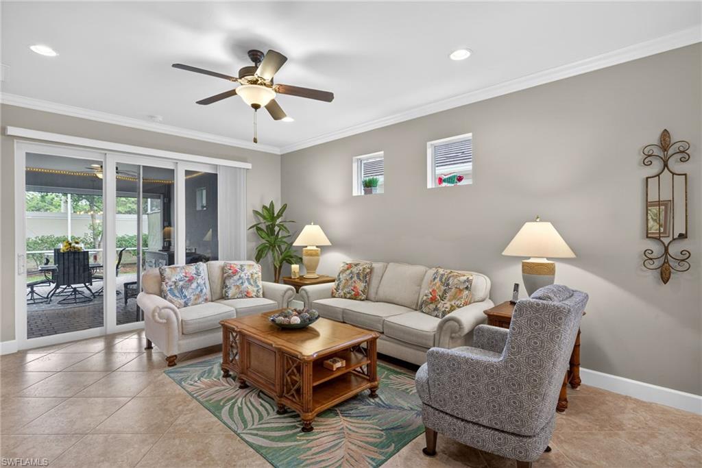 20105 Torch Key Way Estero, FL 33928 - Photo 5 of 29 a living room with furniture and a chandelier