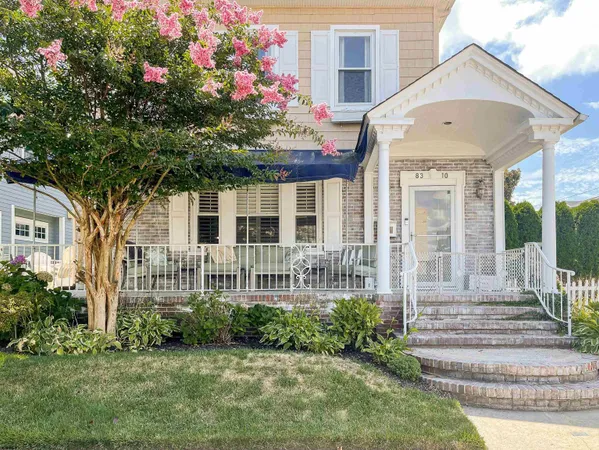 a front view of a house with a garden and plants