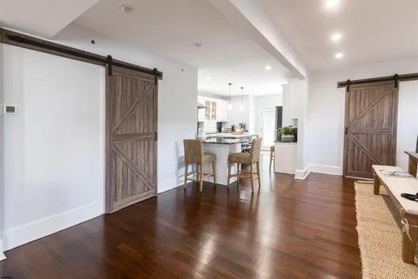 a view of a dining room with furniture and wooden floor