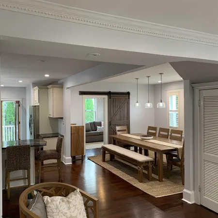 a room with furniture pool table and windows