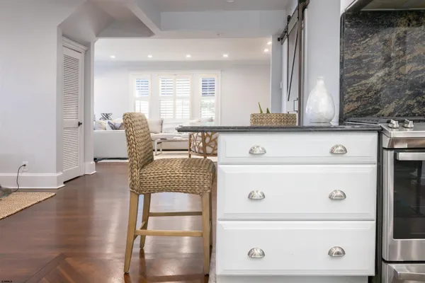a kitchen with a stove cabinets and wooden floor