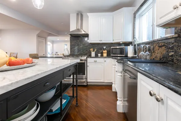 a kitchen with a sink a stove and cabinets