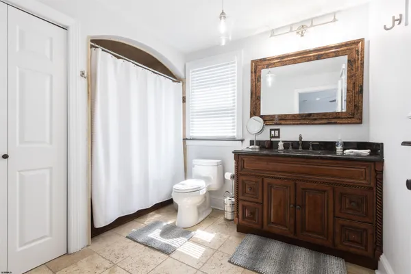 a bathroom with a toilet sink and mirror