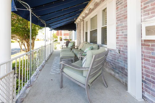 a view of a porch with chairs and backyard