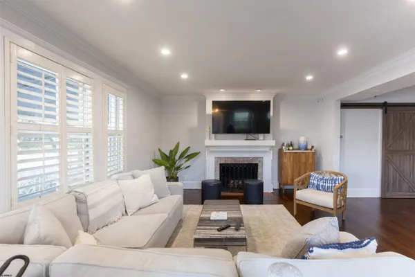 a living room with furniture a fireplace and a flat screen tv