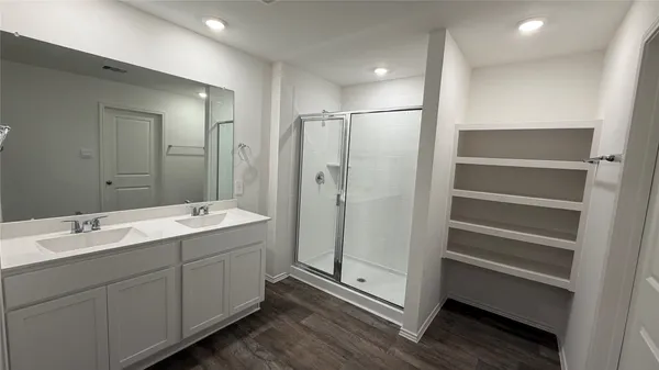 a bathroom with a double vanity sink and mirror