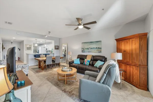 a living room with furniture a ceiling fan and a window