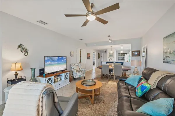a living room with furniture a fireplace and a chandelier
