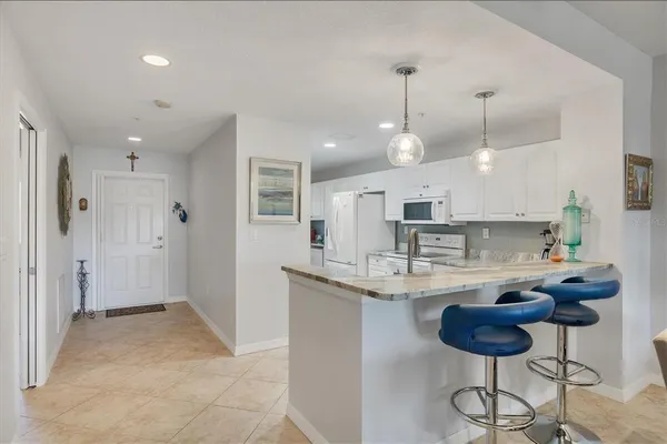 a kitchen with stainless steel appliances granite countertop a sink and a refrigerator