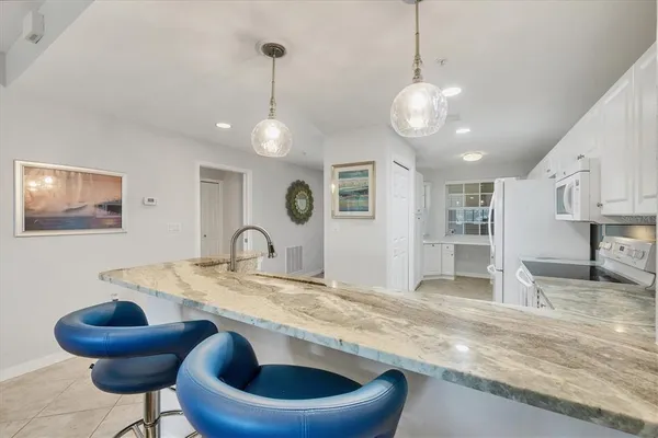 a view of kitchen with granite countertop living room
