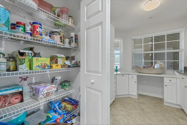 a kitchen with lots of clutter and cabinets