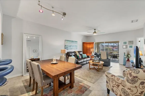 a living room with furniture a flat screen tv and a table