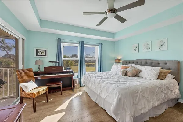 a bedroom with a bed wooden floor and furniture