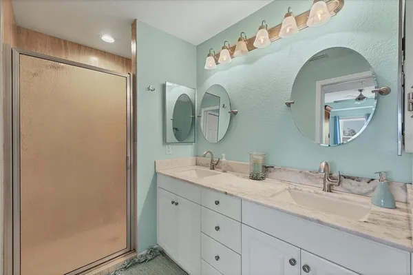 a bathroom with a double vanity sink and a mirror