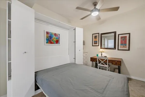 a bedroom with a bed and a table in it