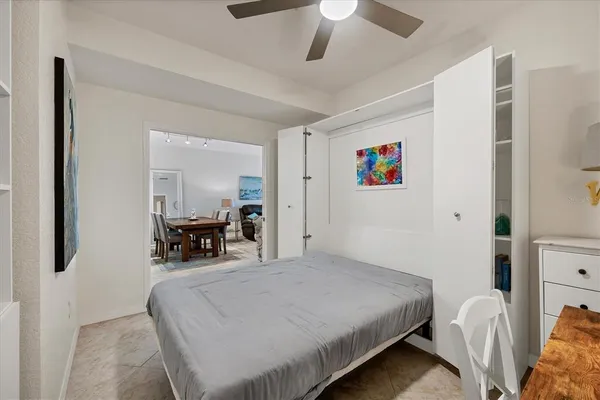 a bed room with a bed and a chair