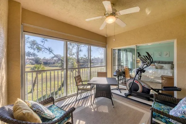 a living room with furniture and a floor to ceiling window