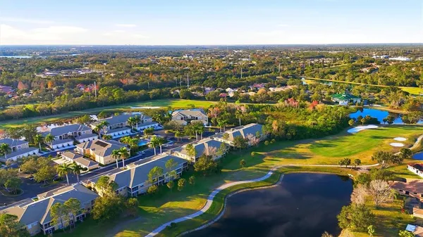 an aerial view of a houses with a lake view