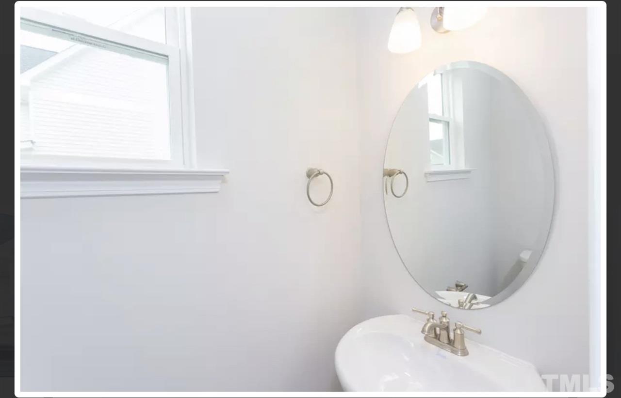 234 Hopper Circle Clayton, NC 27520 - Photo 4 of 22 a bathroom with a sink vanity and a mirror