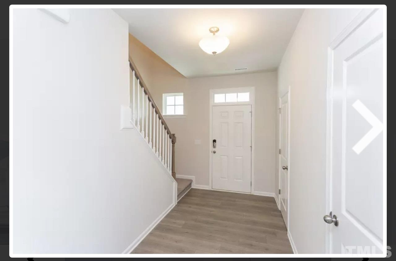 234 Hopper Circle Clayton, NC 27520 - Photo 5 of 22 a view of a hallway with a white walls