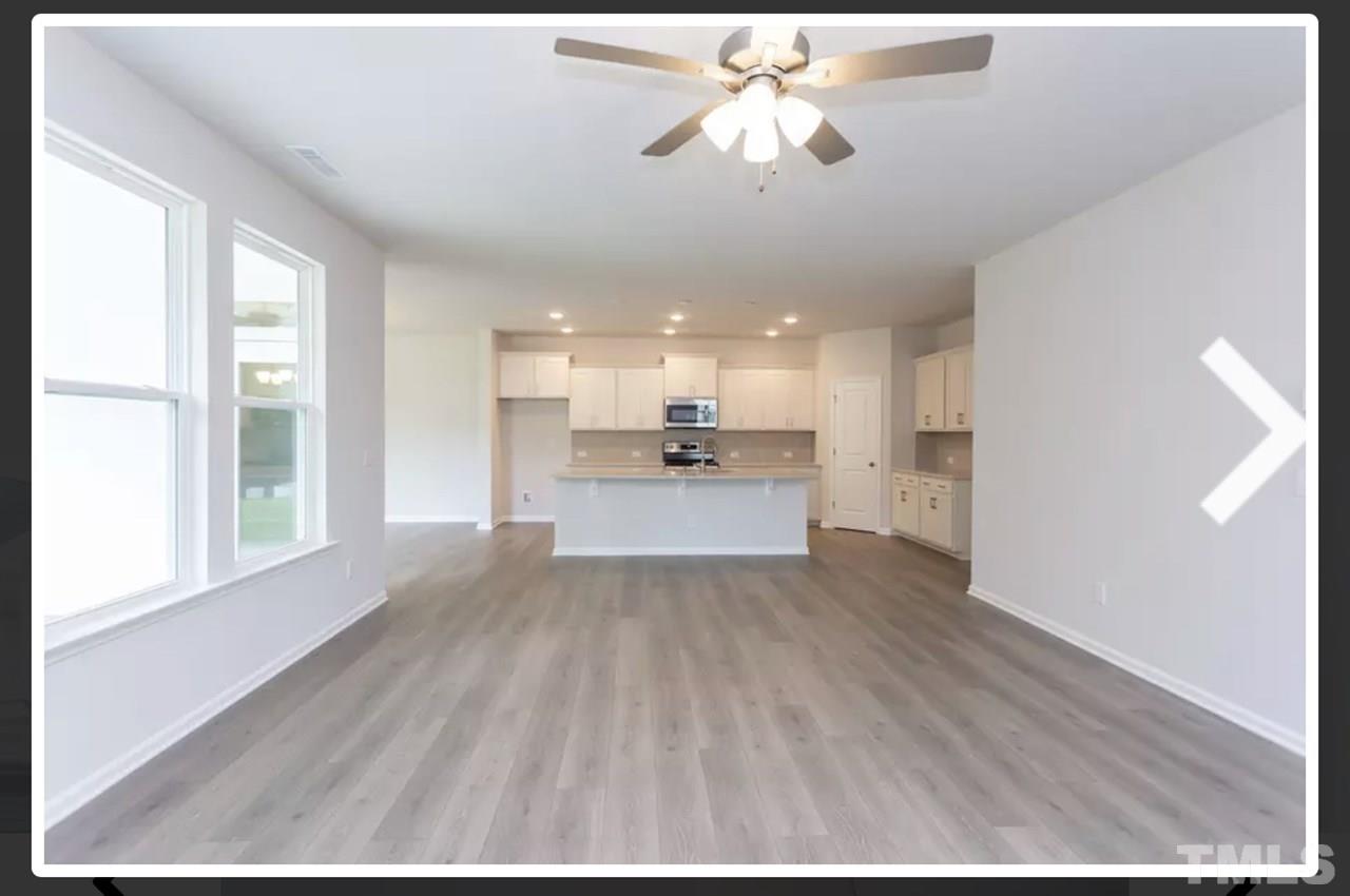 234 Hopper Circle Clayton, NC 27520 - Photo 6 of 22 a view of a kitchen with a sink and wooden floor