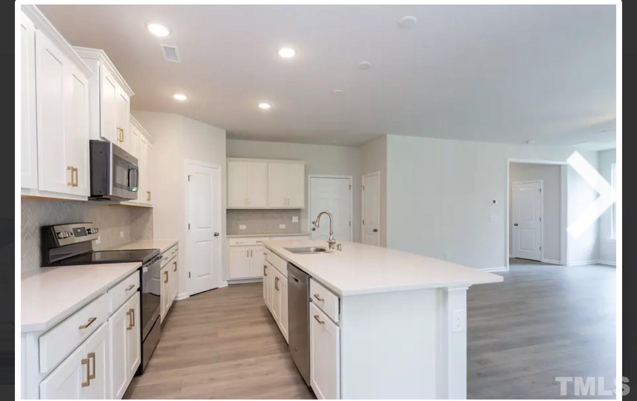 234 Hopper Circle Clayton, NC 27520 - Photo 9 of 22 a kitchen with a sink stove and cabinets