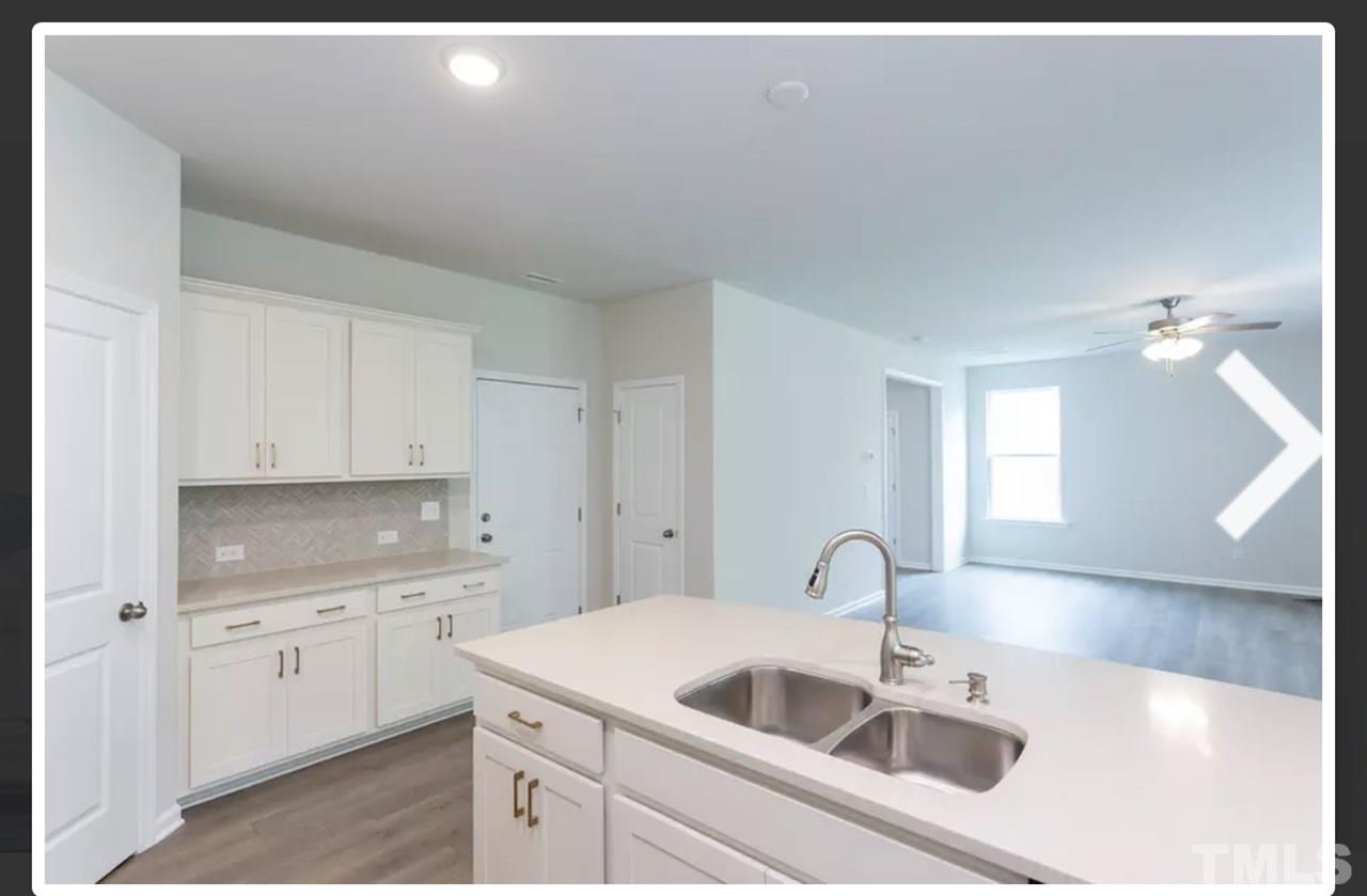 234 Hopper Circle Clayton, NC 27520 - Photo 10 of 22 a kitchen with a sink and cabinets
