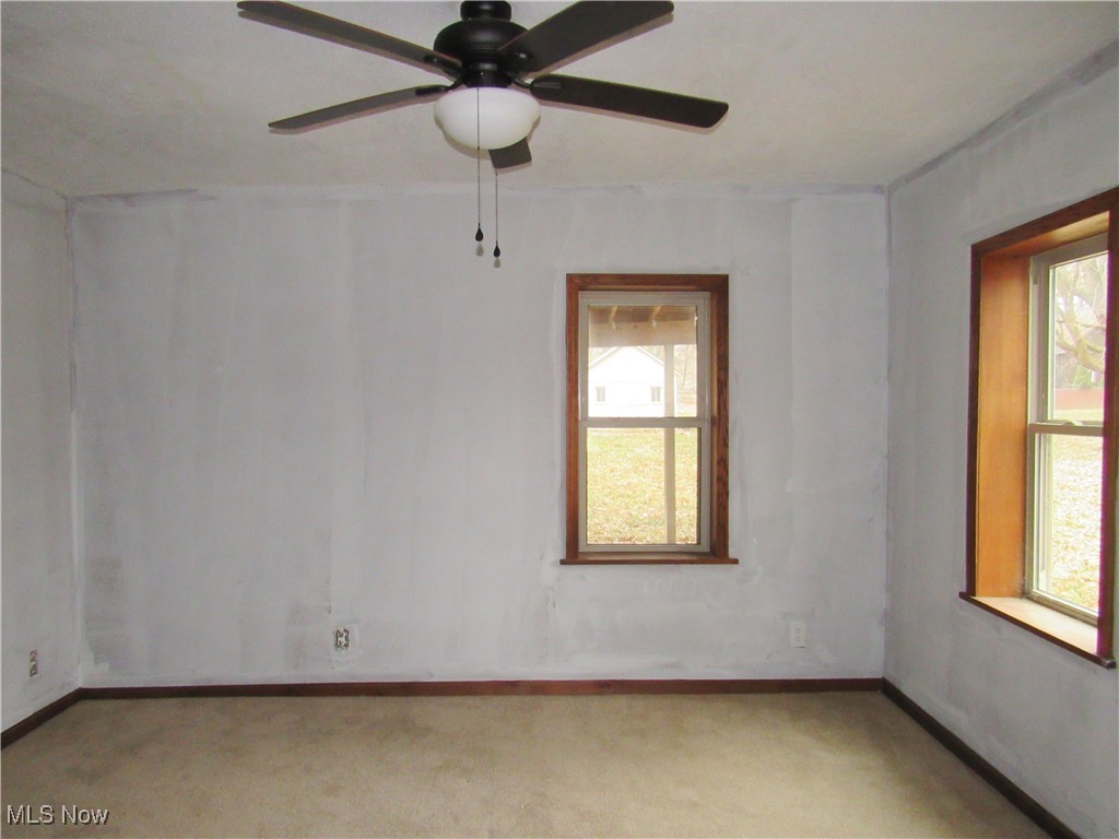 2218 Lake Road Akron, OH 44312 - Photo 6 of 20 Unfurnished room with baseboards and light colored carpet