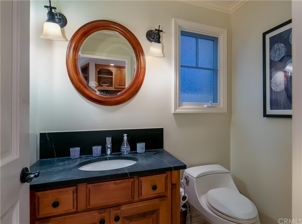 652 Agate Street Laguna Beach, CA 92651 - Photo 11 of 19 a bathroom with a toilet a sink and a mirror