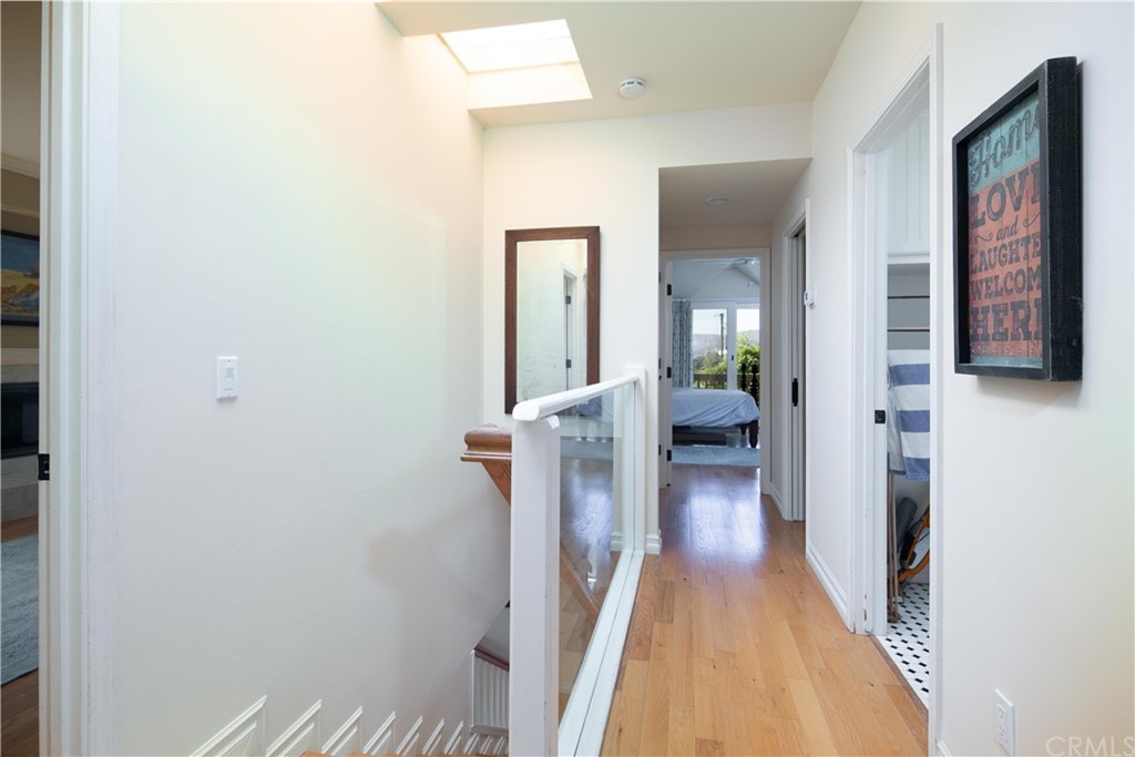 652 Agate Street Laguna Beach, CA 92651 - Photo 13 of 19 a view of a hallway with wooden floor and staircase