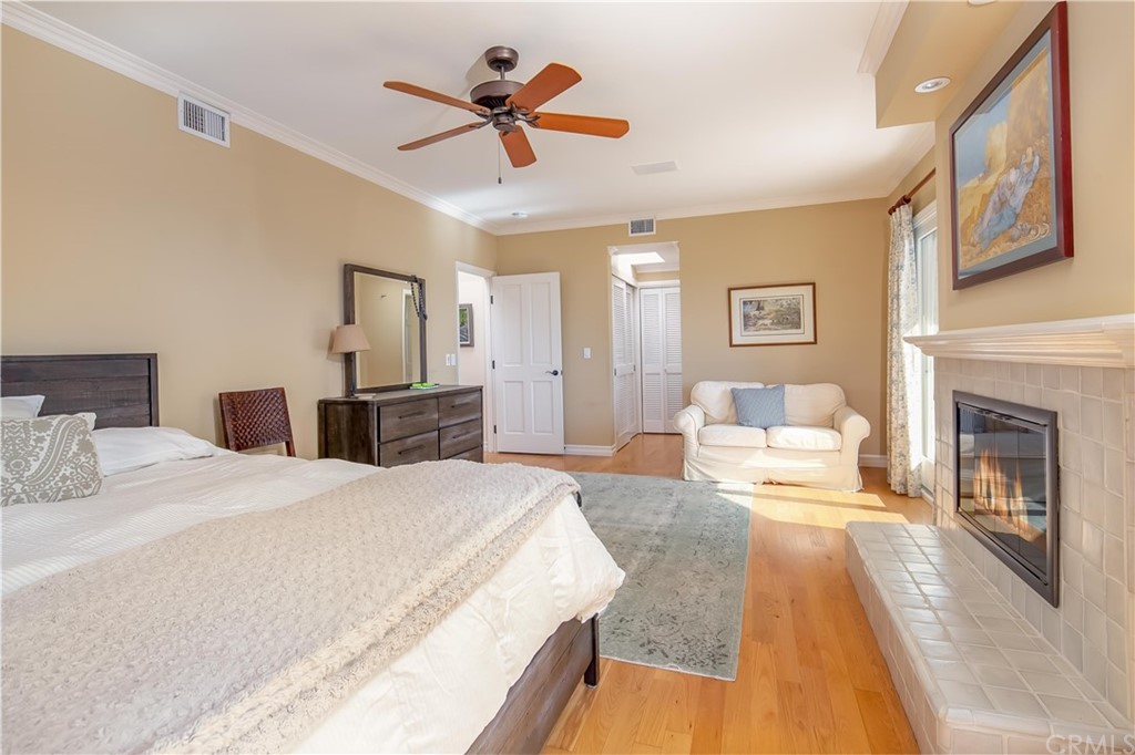 652 Agate Street Laguna Beach, CA 92651 - Photo 15 of 19 a spacious bedroom with a large bed and a chandelier