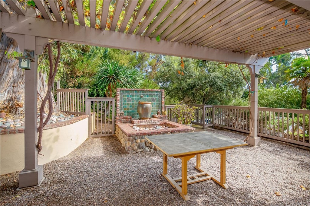652 Agate Street Laguna Beach, CA 92651 - Photo 19 of 19 a view of a patio with a table chairs and a backyard
