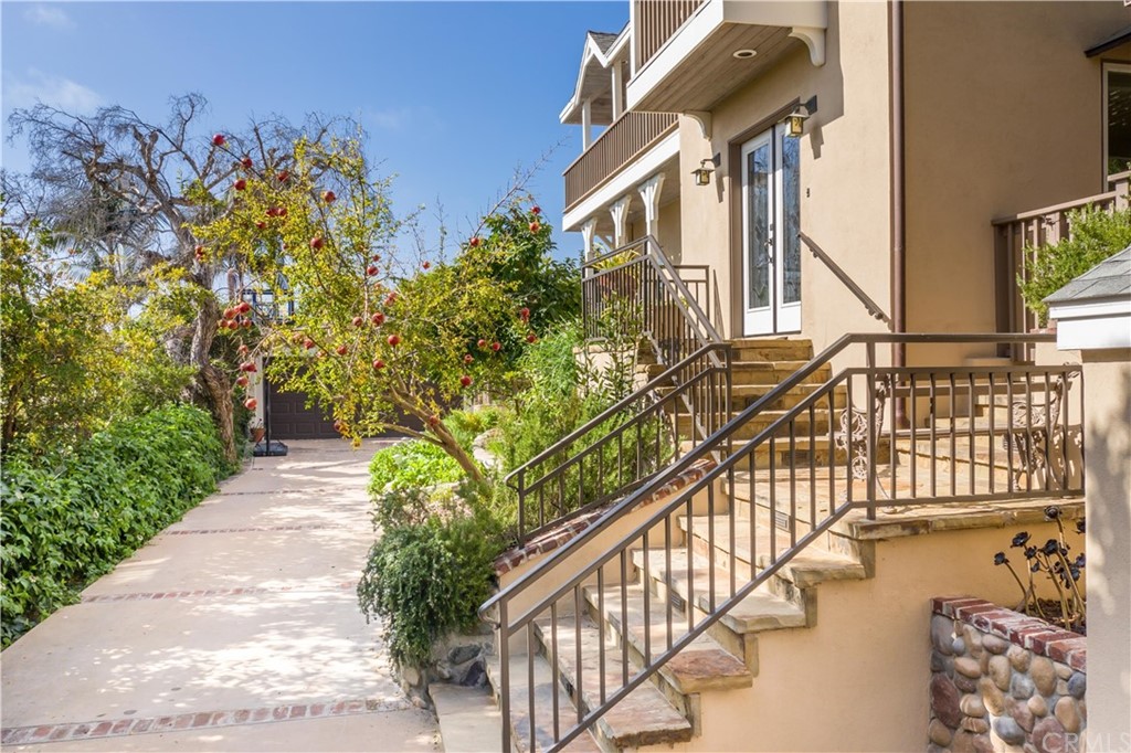 652 Agate Street Laguna Beach, CA 92651 - Photo 4 of 19 a view of a house with large windows and flower plants